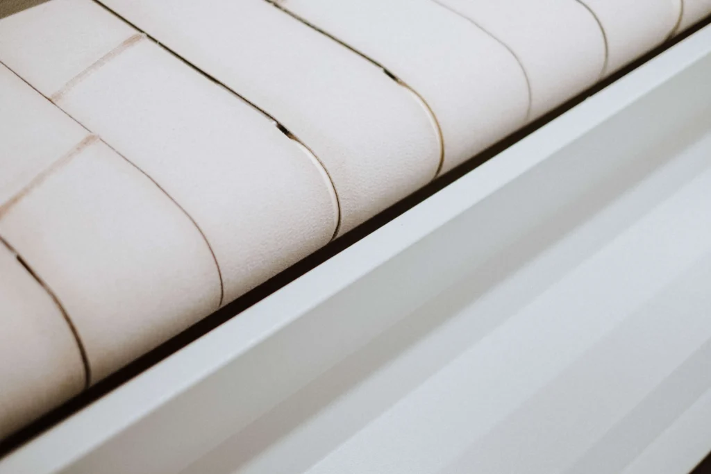 Pressed flat linen leaving the calender ironer